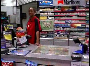 A ebony female working in a store blows